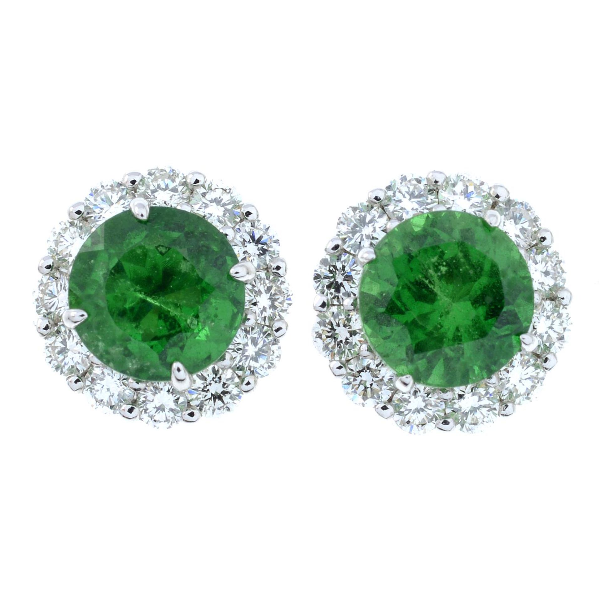 A pair of tsavorite garnet and brilliant-cut diamond cluster earrings.Total tsavorite weight