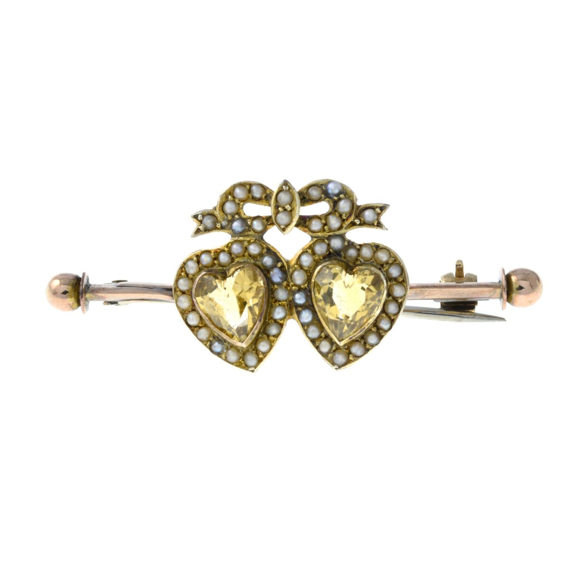 An early 20th century 9ct gold citrine and seed pearl double heart brooch.Stamped 9ct.Length