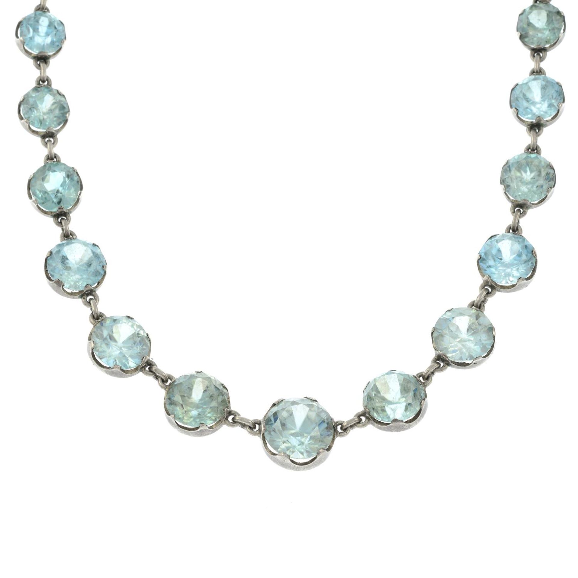 A mid 20th century silver graduated blue zircon riviere necklace.Principal zircon calculated weight