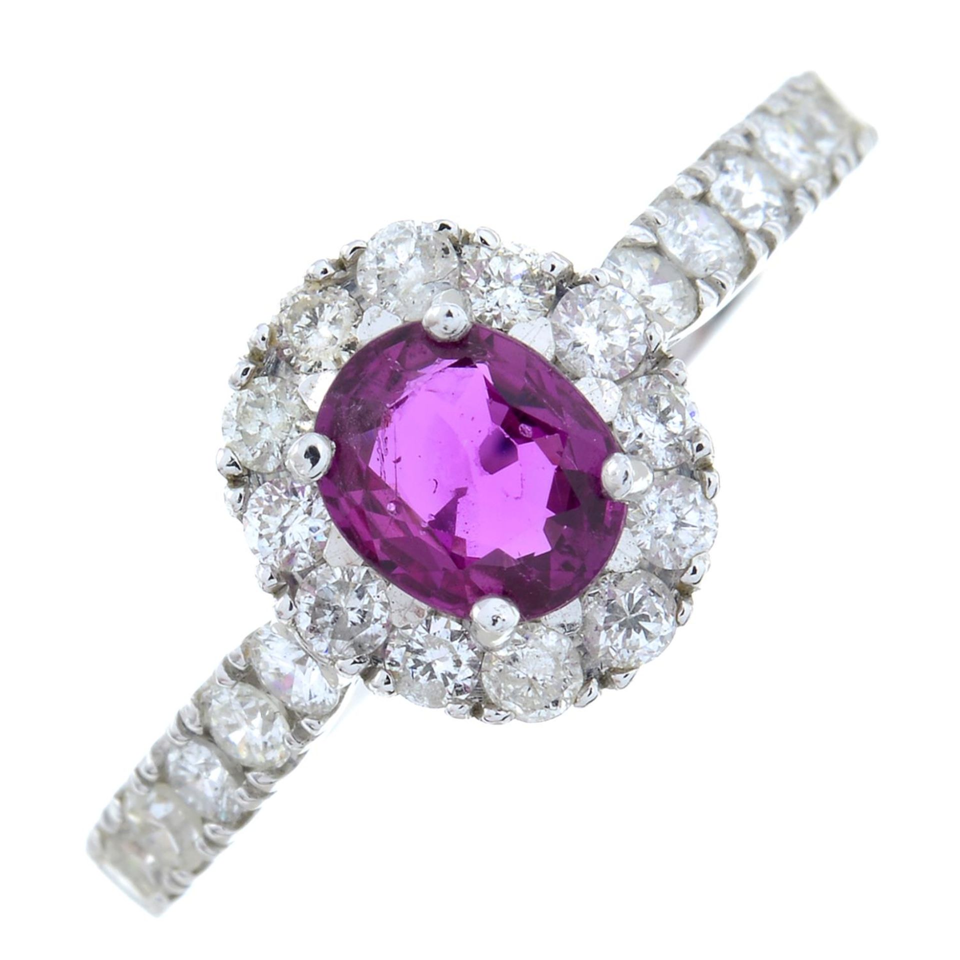 A ruby and brilliant-cut diamond cluster ring.Ruby calculated weight 0.49ct,