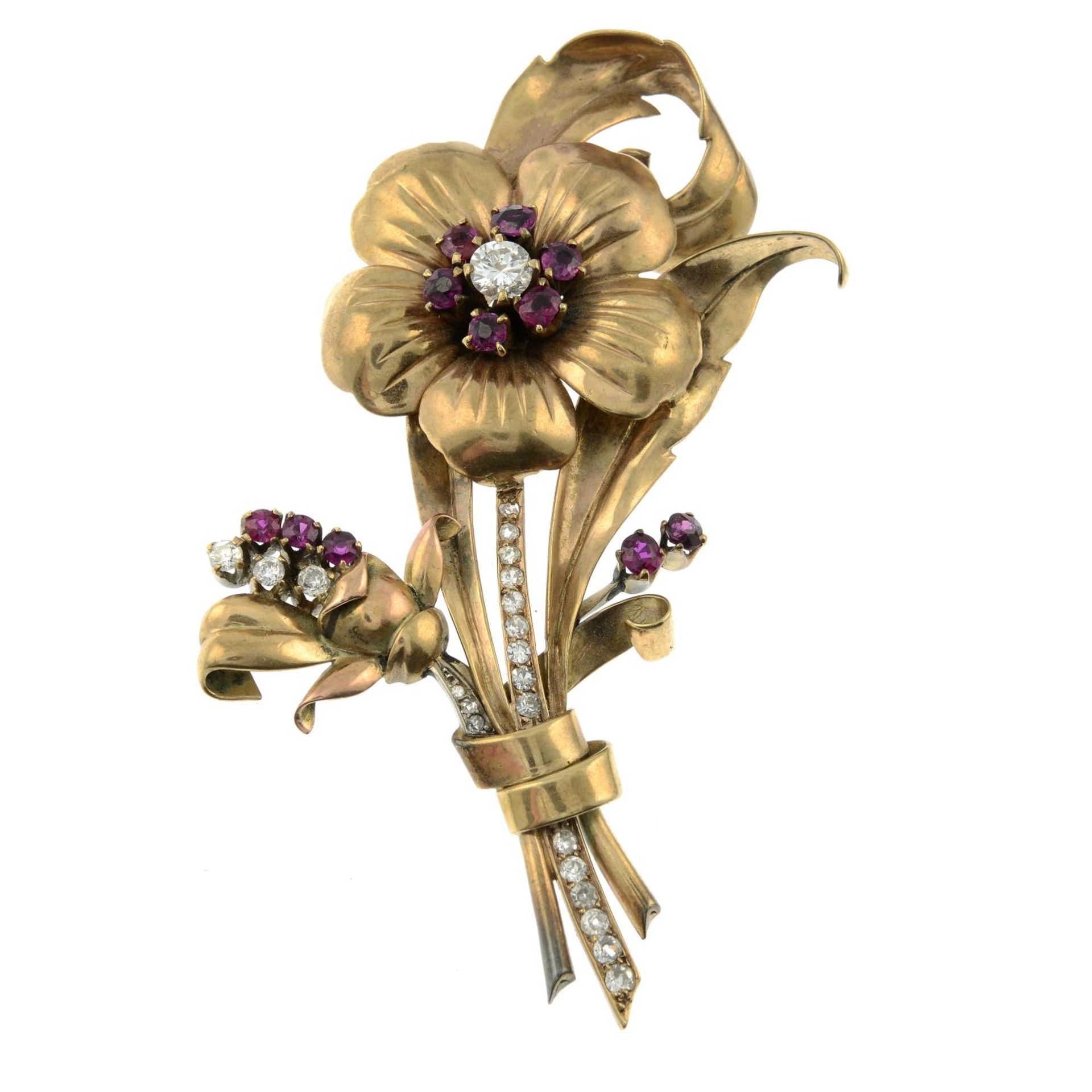 A brilliant-cut diamond and ruby floral brooch.Principal diamond estimated 0.50ct,