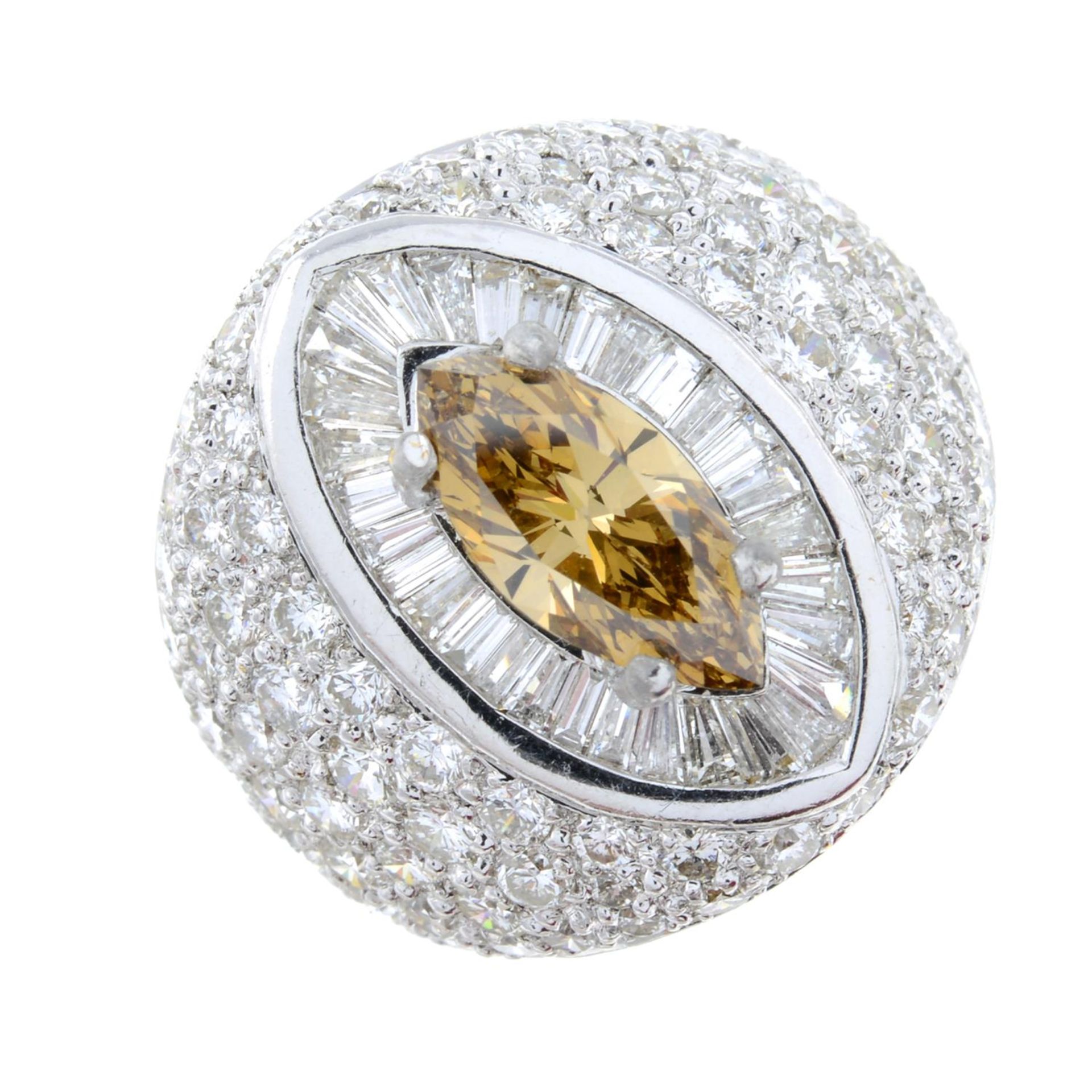 A marquise-shape coloured diamond and vari-cut diamond dress ring.Principal diamond estimated