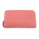 BOTTEGA VENETA - a pink leather wallet.