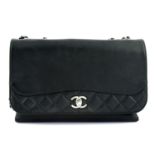 CHANEL - a black leather accordion handbag.
