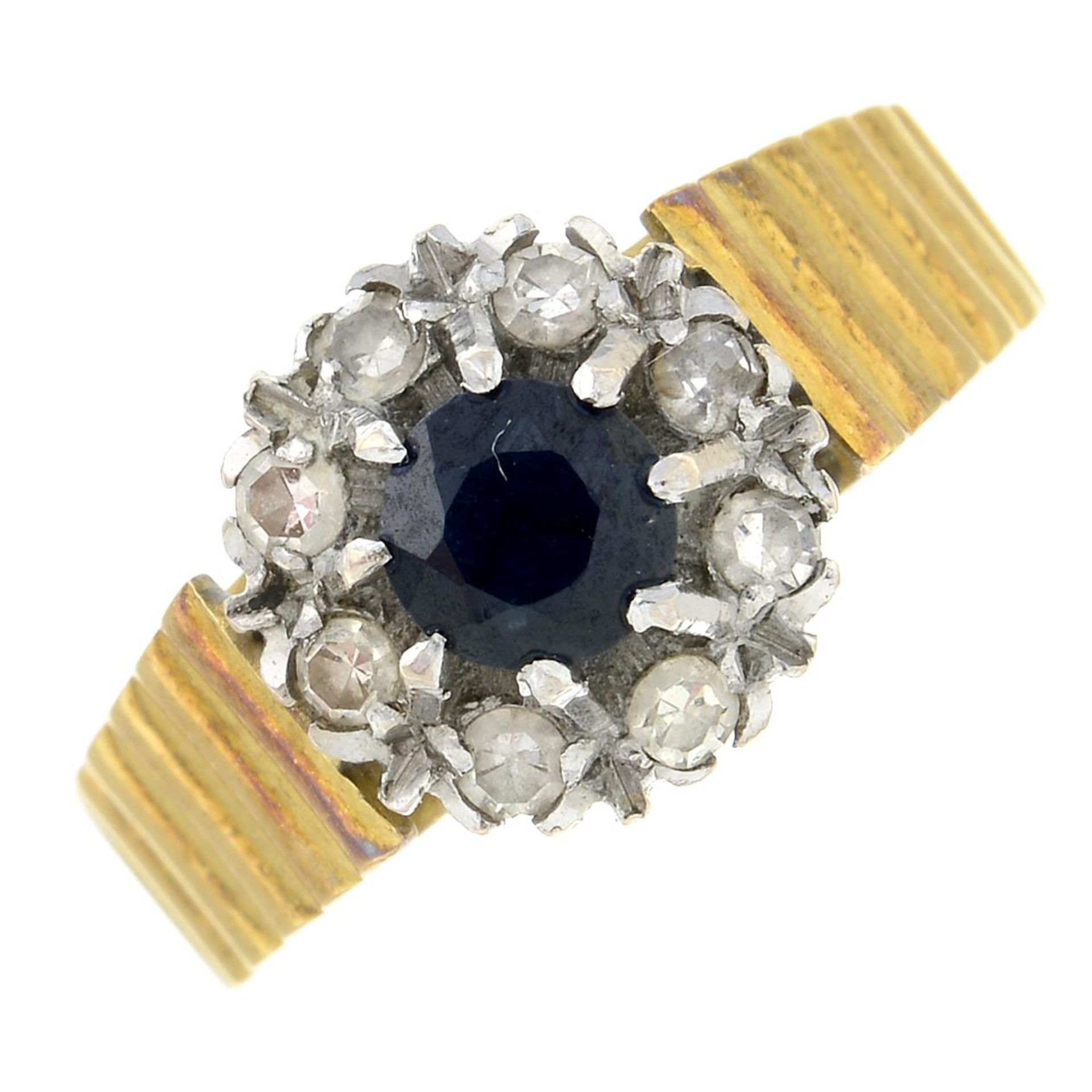 A 1970s 18ct gold sapphire and diamond cluster ring.Estimated total diamond weight 0.15ct.Hallmarks