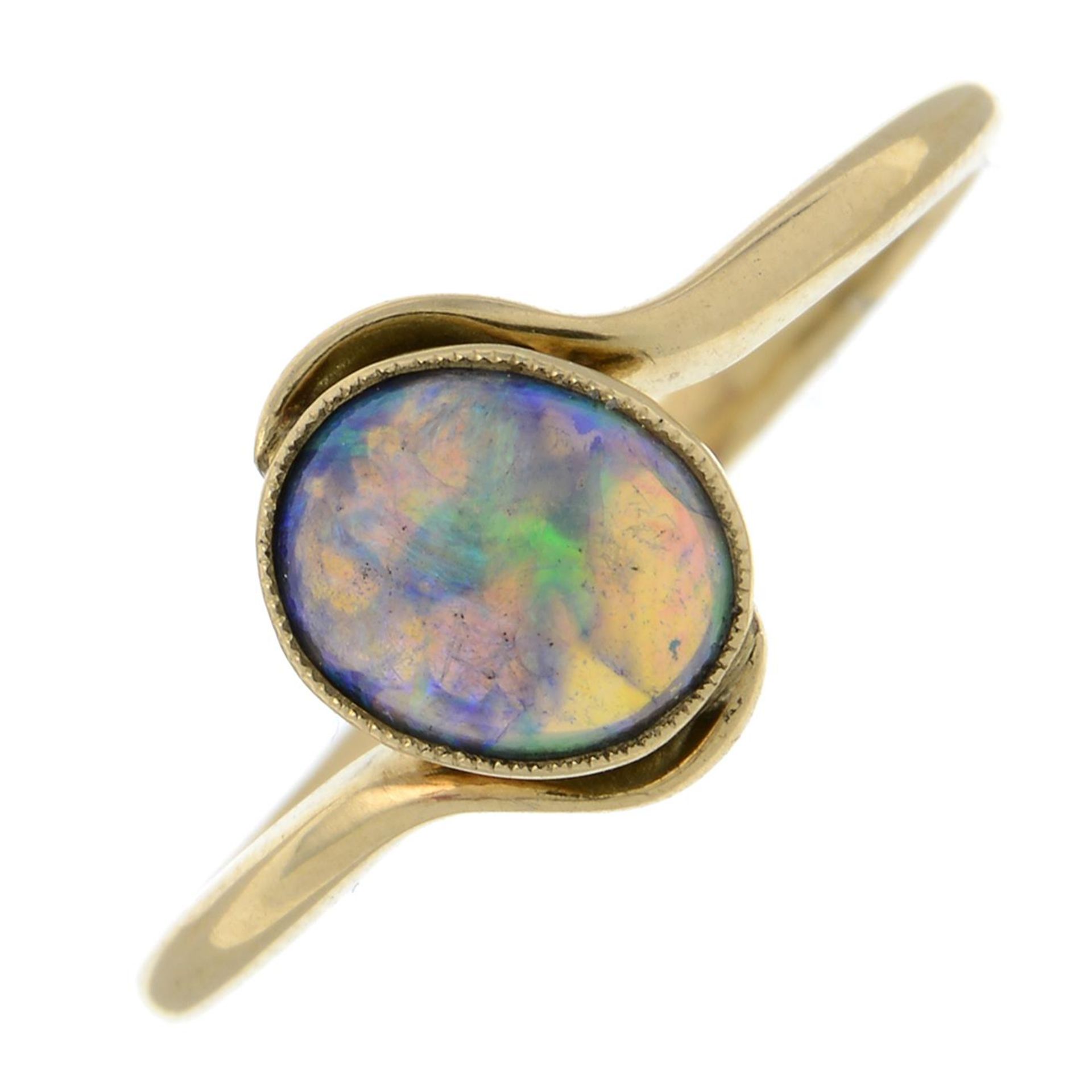 An opal crossover ring.Stamped 18CT.