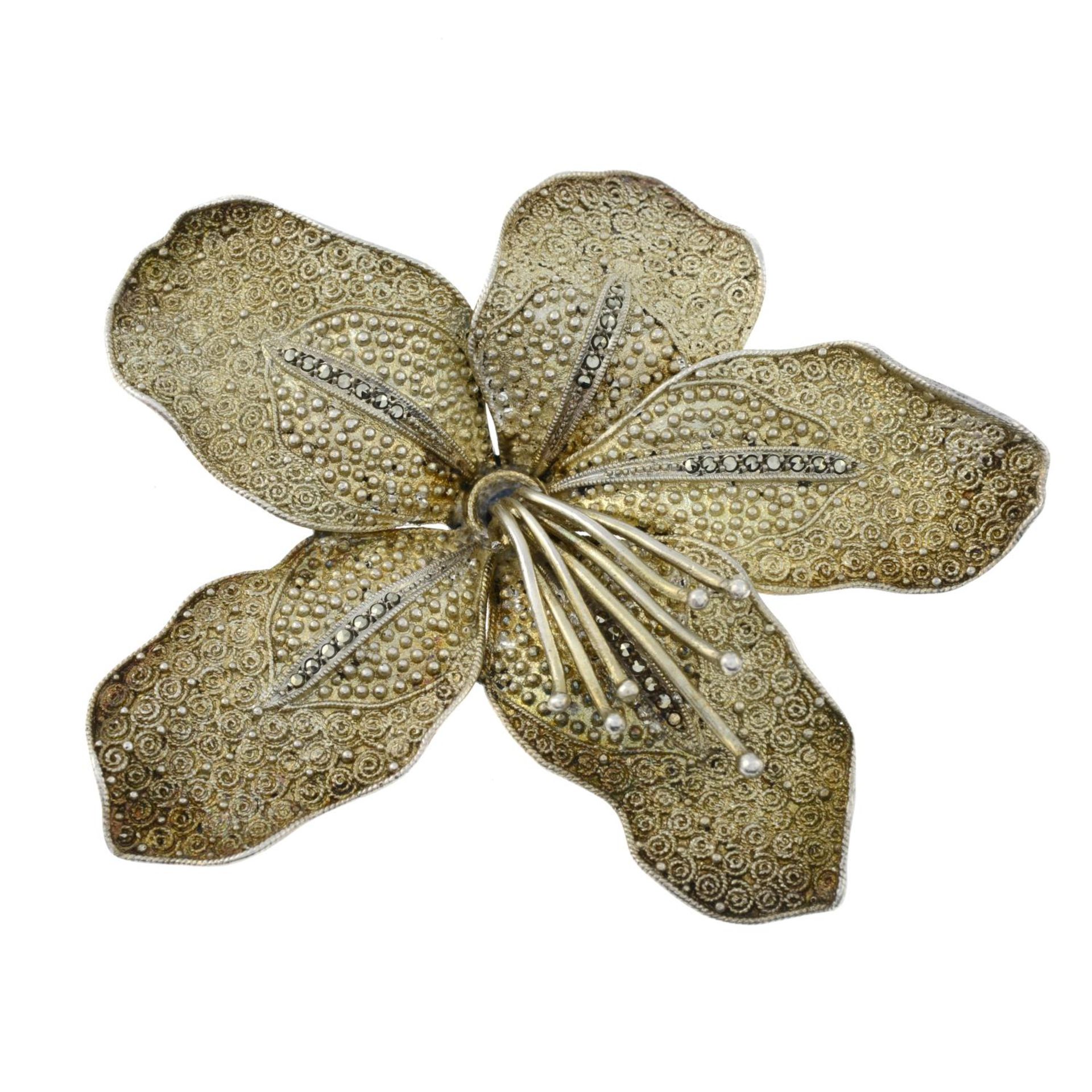 An early 20th century silver gilt and marcasite lily brooch,