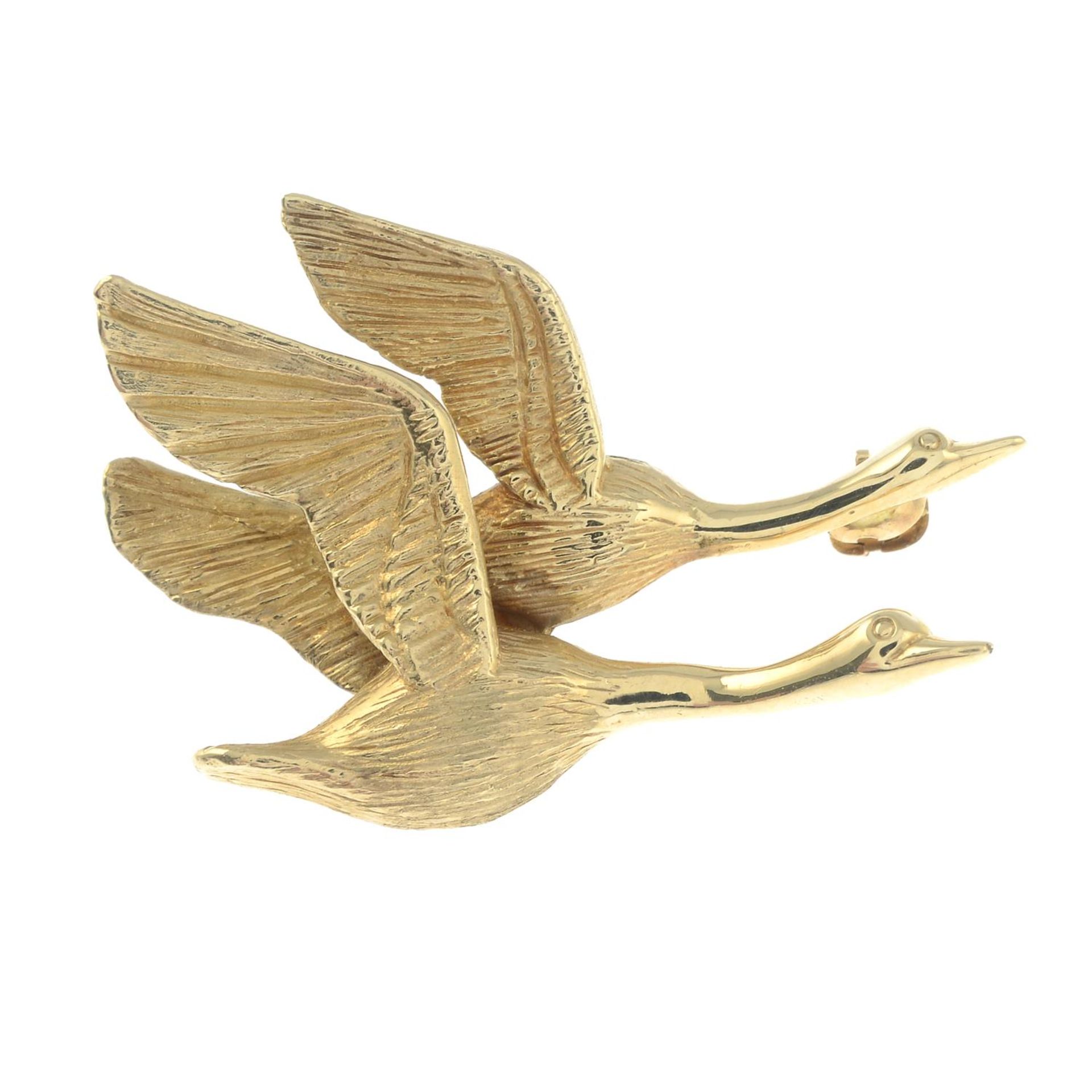 A brooch, designed to depict two birds in flight.Stamped 14K.