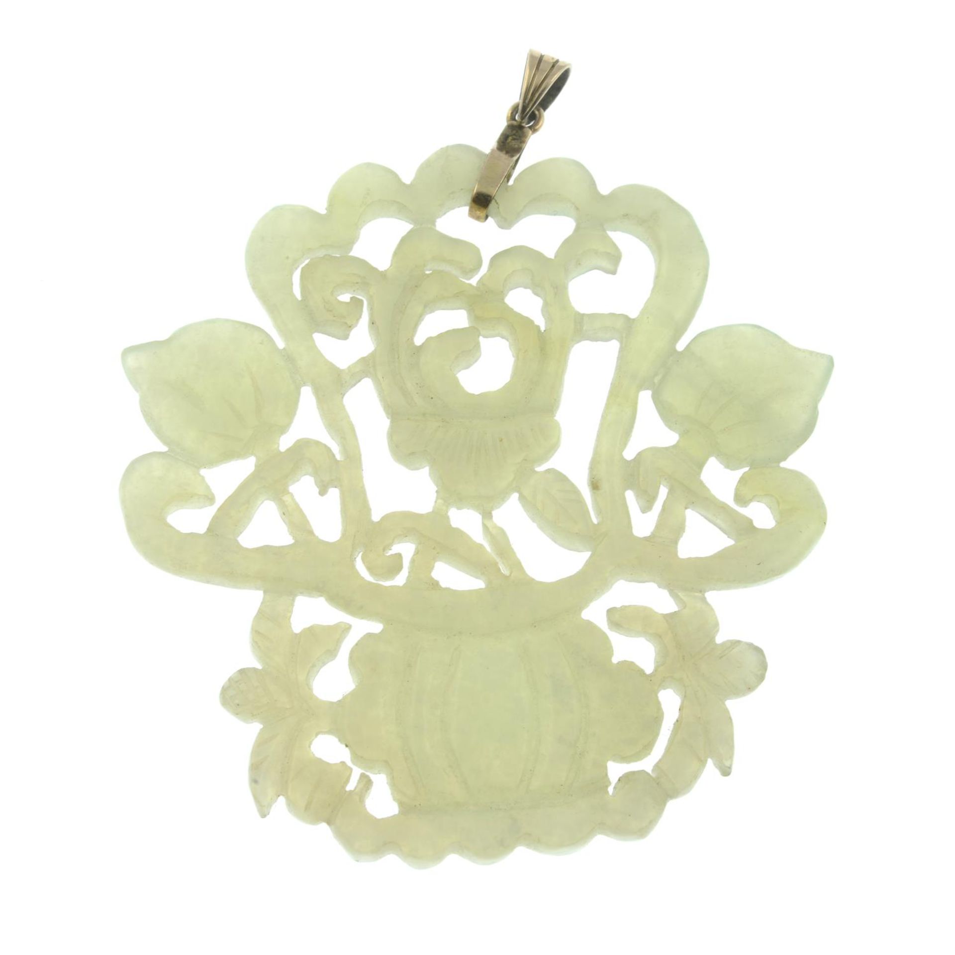 A carved jade foliate pendant.Stamped 9K 375 to mount.Length 6.9cms.