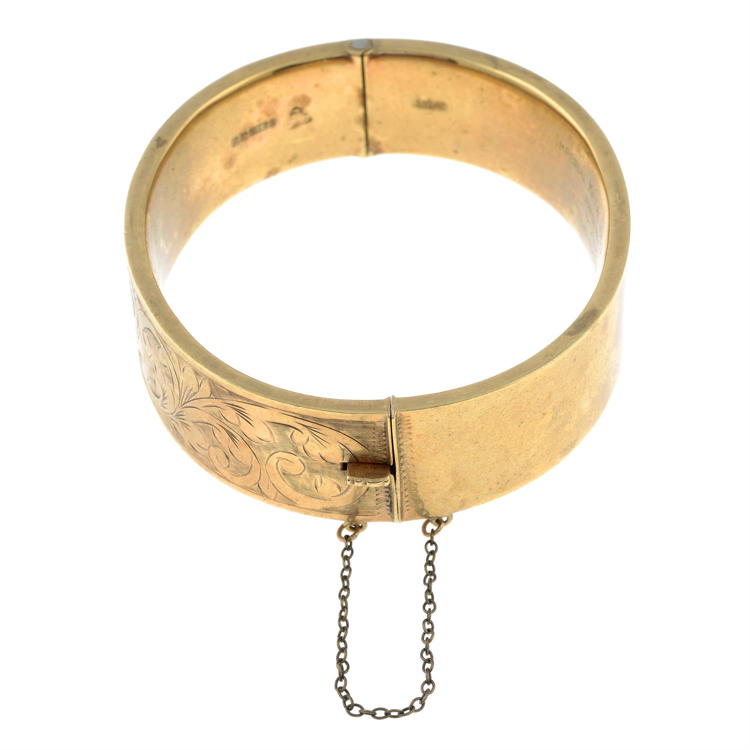 A 9ct gold engraved hinged bangle. - Image 2 of 3