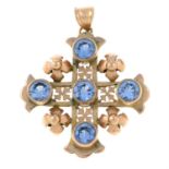 A gold topaz set cross pendant with open work detail.