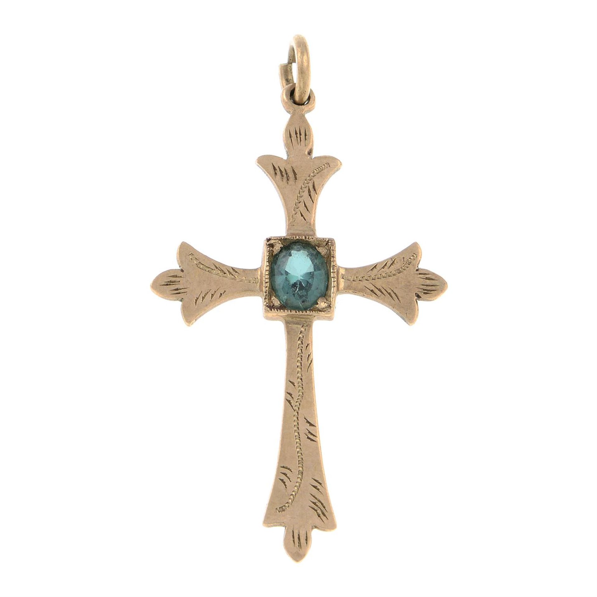 A synthetic spinel cross pendant.