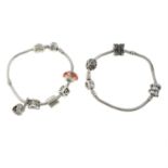 Two charm bracelets, suspending a total of nine charms, by Pandora.