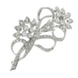 A diamond floral brooch.