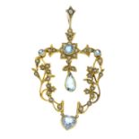 An early 20th century 15ct gold aquamarine, blue paste and split pearl articulated pendant.
