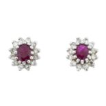 A pair of 9ct gold ruby and diamond cluster earrings.