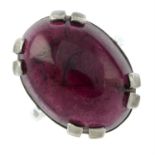 A silver garnet cabochon single-stone ring.