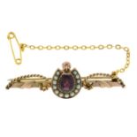 A late 20th century 9ct gold garnet and split pearl horseshoe brooch.