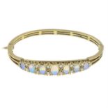 An 9ct gold opal and brilliant-cut diamond set hinged bangle. AF.