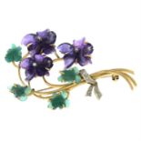 A carved amethyst and chrysoprase brooch with diamond highlights of violet flowers.