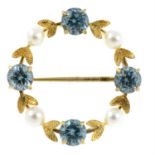 A 9ct gold blue zircon and cultured pearl wreath brooch.