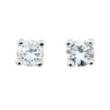 A pair of brilliant-cut diamond stud earrings.