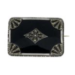 An onyx and marcasite brooch.