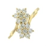 An 18ct gold brilliant-cut diamond flower crossover setting ring.