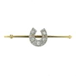 An early 20th century 15ct gold old-cut diamond horseshoe bar brooch.