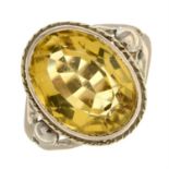 An oval citrine split band cocktail ring.