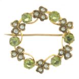 An early 20th century 9ct gold peridot and split pearl wreath brooch.