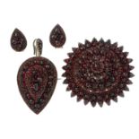 A garnet brooch, pendant and earring set.