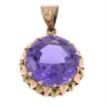 An Egyptian 12ct gold synthetic colour-change sapphire pendant.
