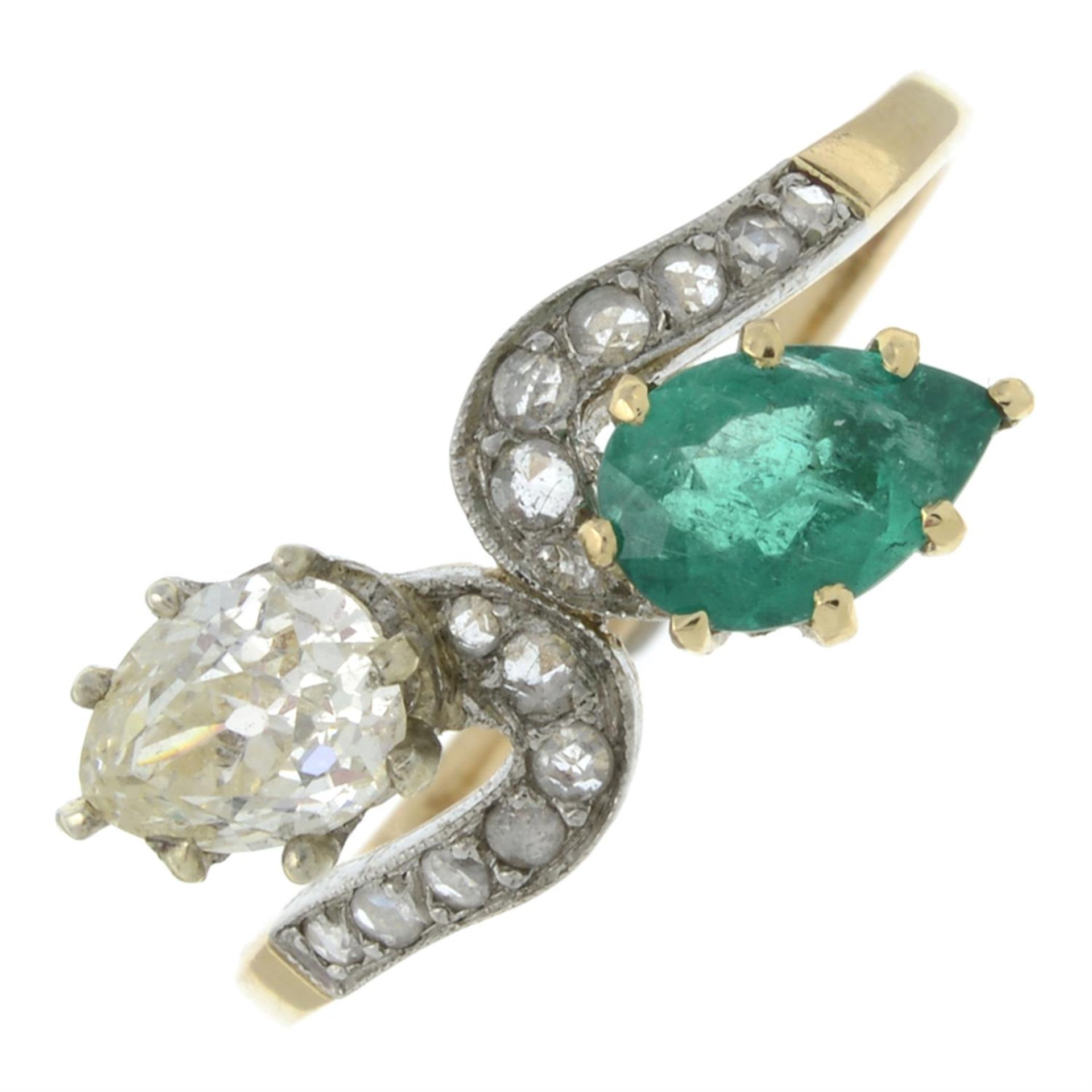 A vari-cut diamond and emerald crossover ring.