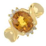 An 18ct gold orange sapphire and brilliant-cut diamond dress ring.