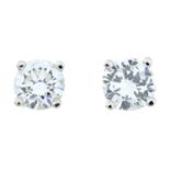 A pair of brilliant-cut diamond stud earrings.