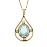 An aquamarine and diamond pendant, suspended from a 9ct gold chain.