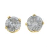 A pair of diamond stud earrings.