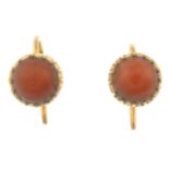 A pair of coral stud earrings.