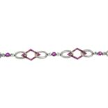 An early 20th century platinum and 14ct gold, ruby and diamond geometric bracelet.