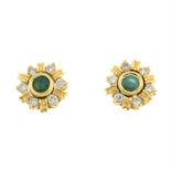 A pair of emerald stud earrings with optional diamond halo.