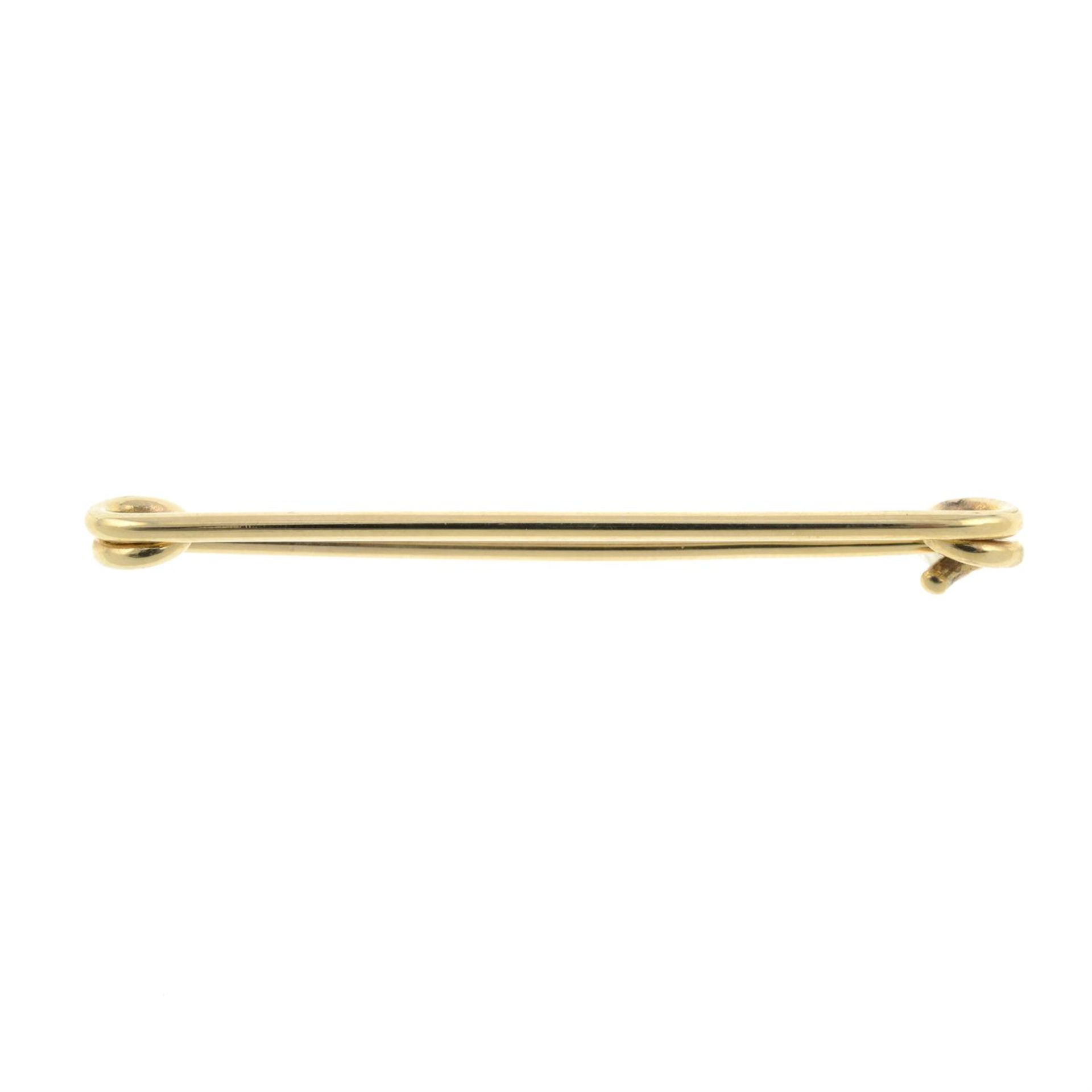 A 9ct gold safety pin.