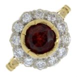 An 18ct gold garnet and brilliant-cut diamond cluster ring.