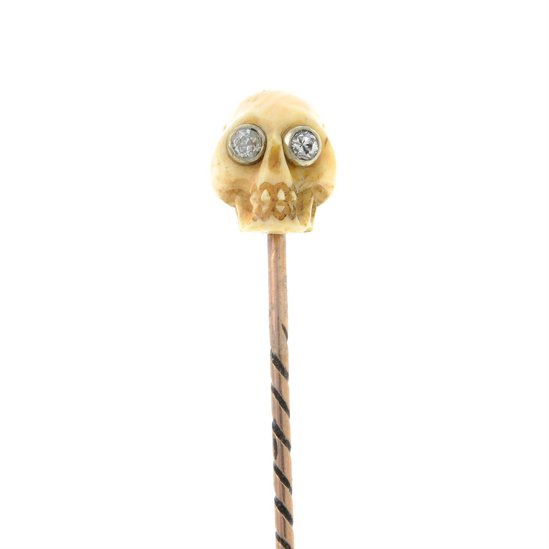 A coral and diamond skull stickpin.