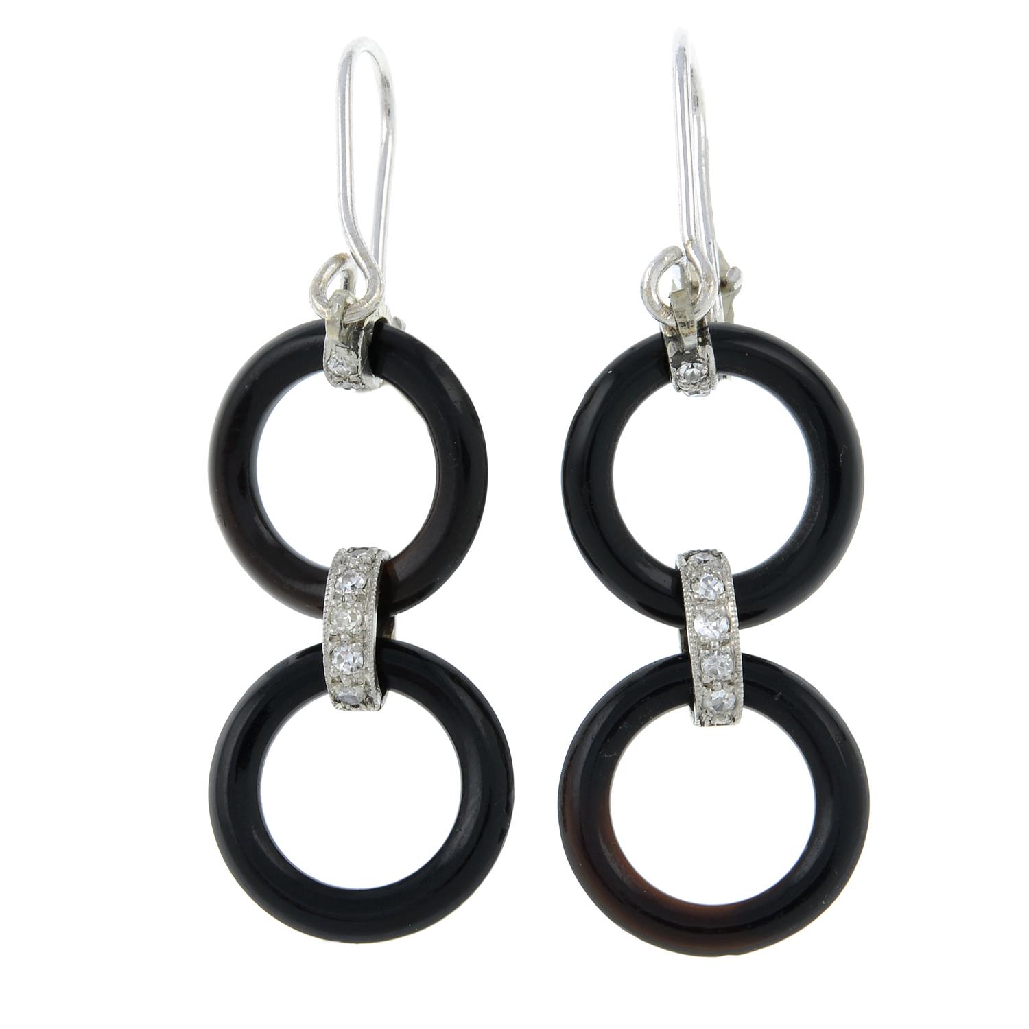 A pair of onyx and diamond drop earrings.