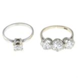 (26935) A brilliant-cut three-stone diamond ring, and a brilliant-cut diamond single-stone ring.