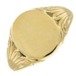 A 9ct gold signet ring with scrolling shoulders.