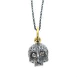 A silver hammered skull pendant with 18ct gold bail and rose-cut diamond eyes, with chain.