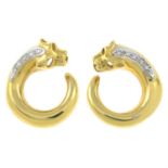 A pair of diamond panther hoop earrings.