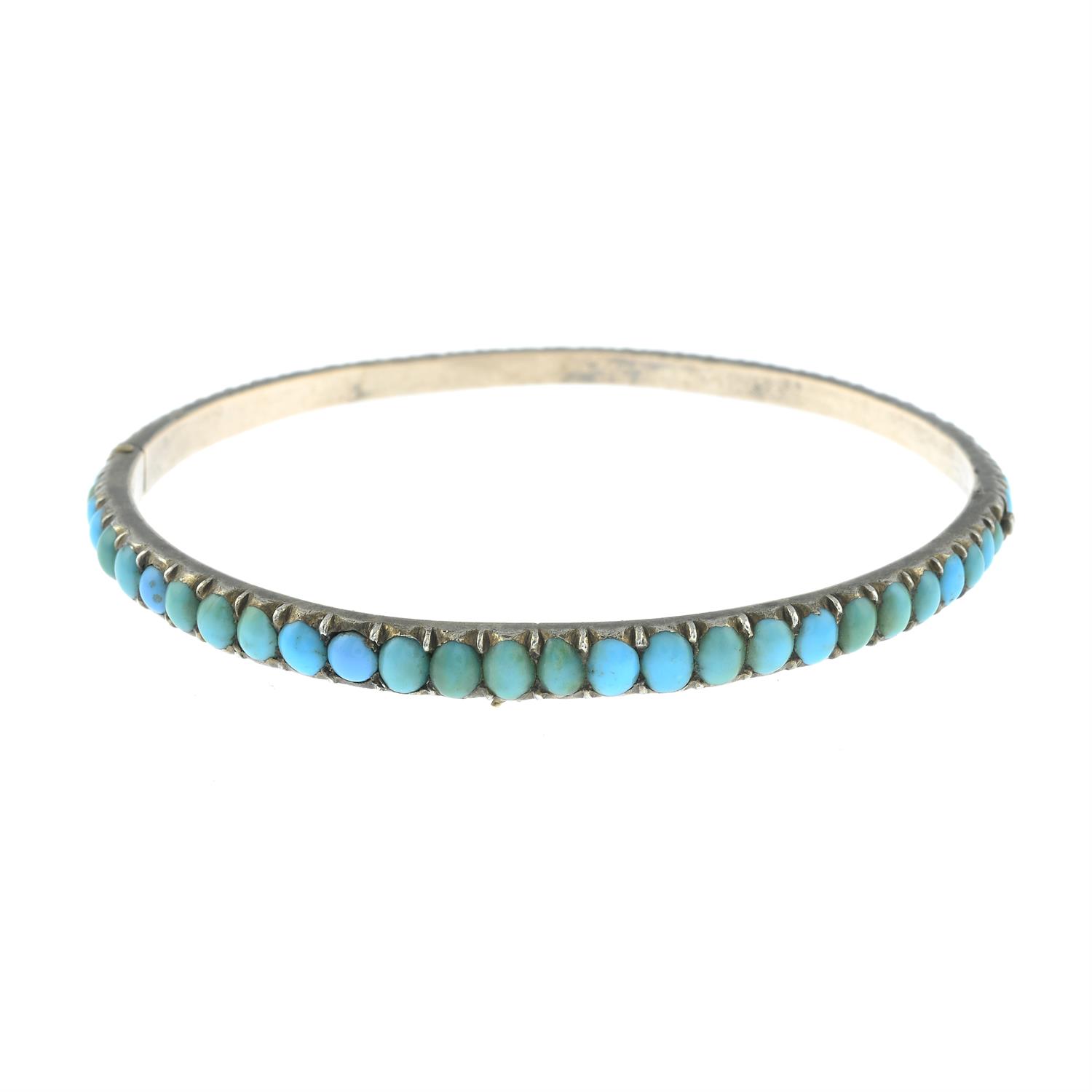 A late 19th century silver, turquoise hinged bangle.